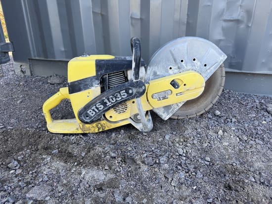 Yellow Wacker BTS 1035 gas concrete saw with a 14-inch blade, resting on gravel