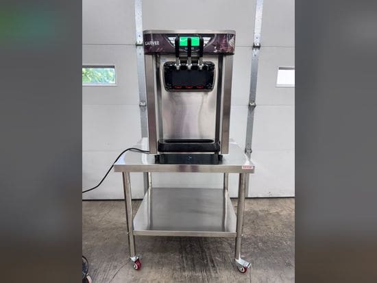 Countertop soft-serve ice cream machine with three dispensing handles, shown on a stainless steel stand