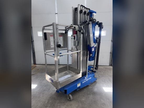 Blue Genie AWP-30S push-around personnel lift with its platform lowered, parked in a shop