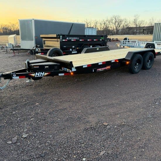 Black H&H tandem-axle car trailer with a wood deck