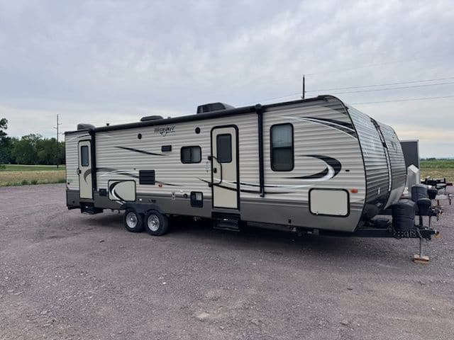 Keystone Hideout travel trailer parked on a gravel lot