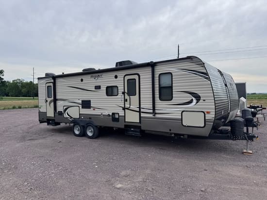 Keystone Hideout travel trailer parked on a gravel lot